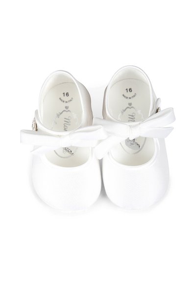 Scarpe per bambini in tessuto bianco, con punta arrotondata, cinturino regolabile e un'accento a fiocco su ogni scarpa. L'etichetta della taglia all'interno riporta "16."
