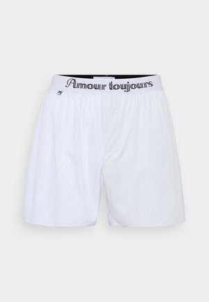 Białe bokserki w paski z elastycznym paskiem w talii z napisem "Amour toujours" w czarnym kolorze. Lekka tkanina, luźny krój.