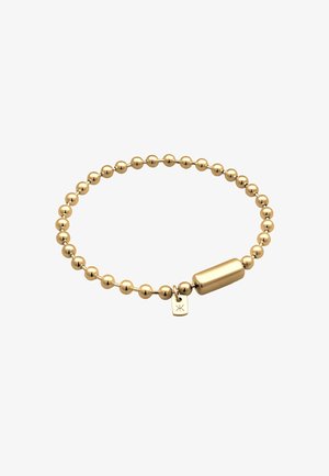 Aranygyöngyös karkötő, sima henger alakú középső résszel és csillag szimbólummal ellátott kis címkével, kiemelve a fényes felületet.