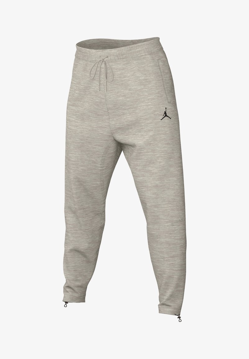 Grijze jogbroek van zacht, textuurstof, met een elastische tailleband met trekkoord en ritsen aan de onderkant. Zwart logo aan de zijkant.