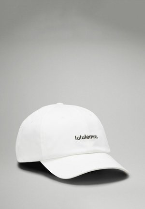 White cap made of fabric, featuring a curved brim and a black "lululemon" logo on the front. Smooth texture and no additional patterns.