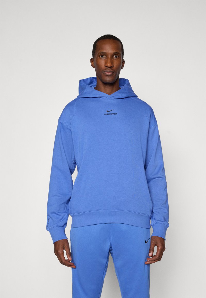 Blue Nike Pro hoodie with a front kangaroo pocket, ribbed cuffs, and logo accent on the chest. Soft fabric with a relaxed fit.