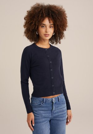 Navy blue cardigan with long sleeves, round neck, and button front. Made of soft material, featuring a cropped design and ribbed hem.