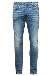 Modré úzké džíny z denimu s vybledlým efektem, designem s pěti kapsami a jemným efektem šisování, vybavené zipem a kovovým knoflíkem.