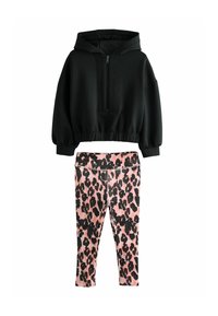 Sweatshirt noir à capuche avec une fermeture éclair à l'avant et des poignets élastiques, associé à un legging rose avec un motif léopard noir.