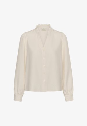 Blusa crema de manga larga con botones al frente, textura sutil de puntos, cuello con volantes y puños fruncidos de la marca Kaffe.