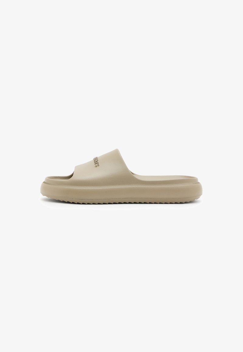 Beige rubber slide sandal with a contoured footbed, wide strap, and textured sole. Features a subtle logo on the strap and a smooth finish.