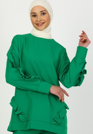 Green sweatshirt with ruffled sleeves and hem, made from soft fabric, featuring a relaxed fit and crew neckline.