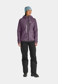 Purple insulated jacket with a hood and two zippered front pockets, paired with black pants and black mountaineering boots. Blue headband accessory.