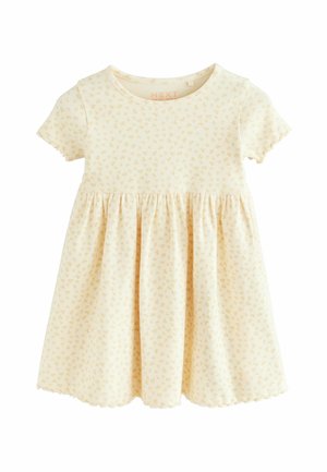 Robe bébé à manches courtes couleur crème avec petit motif floral jaune et jupe froncée, en tissu côtelé doux.