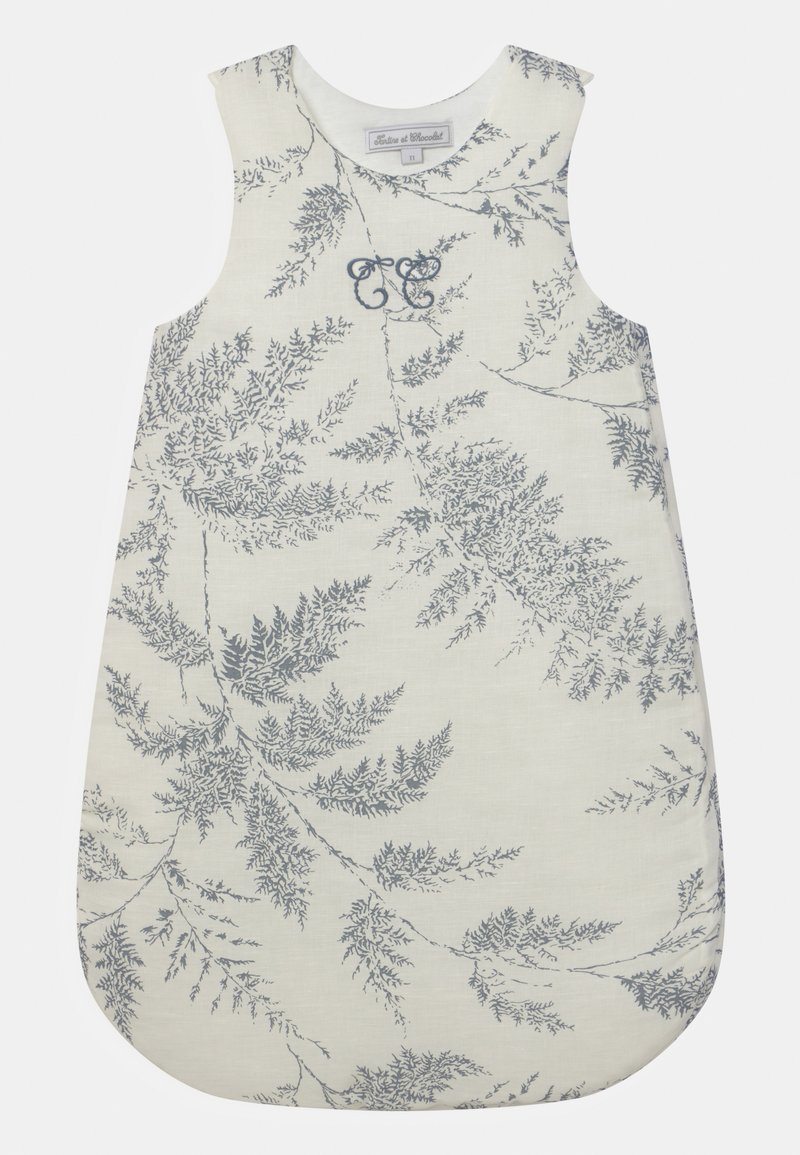 Sleep sack in light cream fabric with blue fern pattern. Features rounded bottom and wide shoulder straps. Embroidered accent detail.