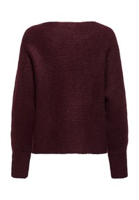 Pull en maille bordeaux avec une finition texturée, des manches larges et un design court. Il possède des poignets côtelés et une silhouette carrée.