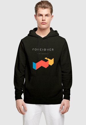 Black hooded sweatshirt featuring a front graphic with the word "FOREIGNER" above geometric shapes in blue, red, and yellow.