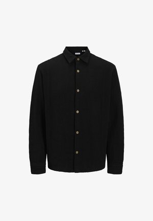 Chemise noire à boutons, fabriquée en tissu texturé. Caractéristiques : col pointu, manches longues et boutons marron sur le devant.