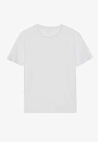 Tricou alb cu mânecă scurtă, fabricat dintr-un material de bumbac moale. Are un guler rotund și o croială lejeră. Fără modele sau accente suplimentare.
