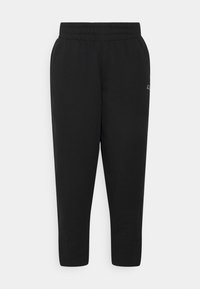 Black stretch joggers with an elastic waistband, tapered legs, and a small logo detail near the waist. Made from a soft, comfortable fabric.