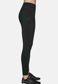 Czarne sportowe legginsy z wysokim pasem, teksturowanymi akcentami w prążki po bokach oraz kieszonką na zamek na udzie.