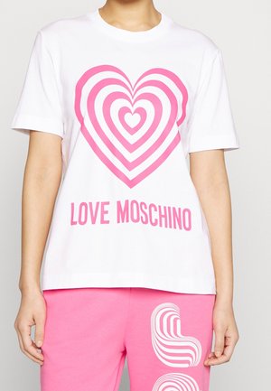 White T-shirt with concentric pink heart design and "LOVE MOSCHINO" text, paired with pink pants featuring abstract white patterns.