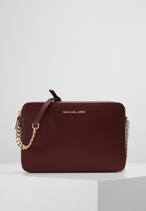 Ciemnobordowa torebka na ramię Michael Kors z złotym łańcuszkowym paskiem i minimalistycznym prostokątnym wzorem na białej powierzchni.