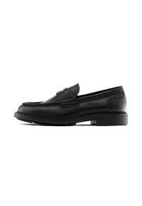 Black leather loafers with a rounded toe, stitched detailing, and a flat rubber sole. Features a front strap design.