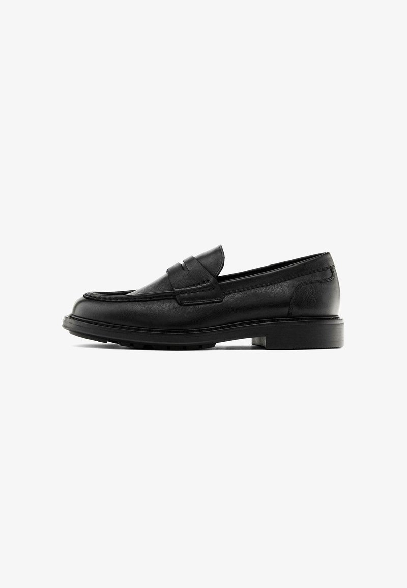 Black leather loafers with a rounded toe, stitched detailing, and a flat rubber sole. Features a front strap design.