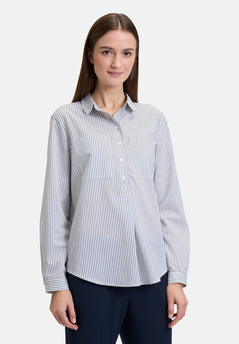 Striped button-up shirt with a collared neck, long sleeves, and a curved hem. Made from lightweight fabric in white and navy blue.