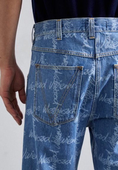 Blue denim jeans featuring a repeating white logo pattern, five-pocket design, visible stitching, and a distinctive back pocket shape.