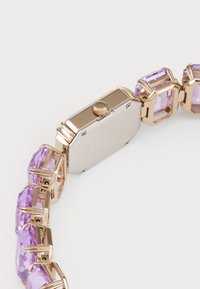 Gold-toned watch with a rectangular silver case, featuring multiple purple gemstone accents in a linked band design.