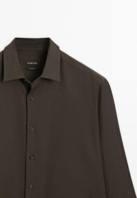 Brown long-sleeve shirt with a classic collar, features black buttons and a soft, textured fabric. Label reads "Massimo Dutti."