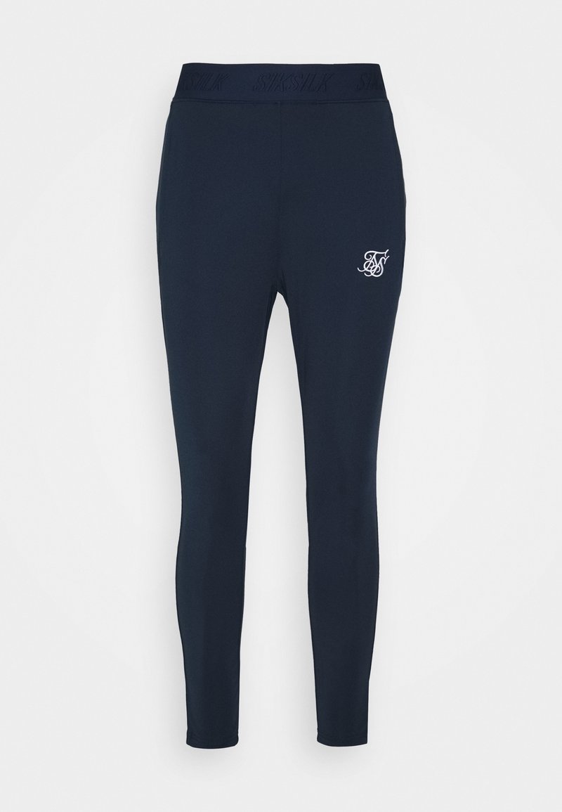 Leggings marinos con un diseño ajustado, fabricados con tela suave. Presentan un logo en el muslo y una cinturilla elástica con la marca "SikSilk".