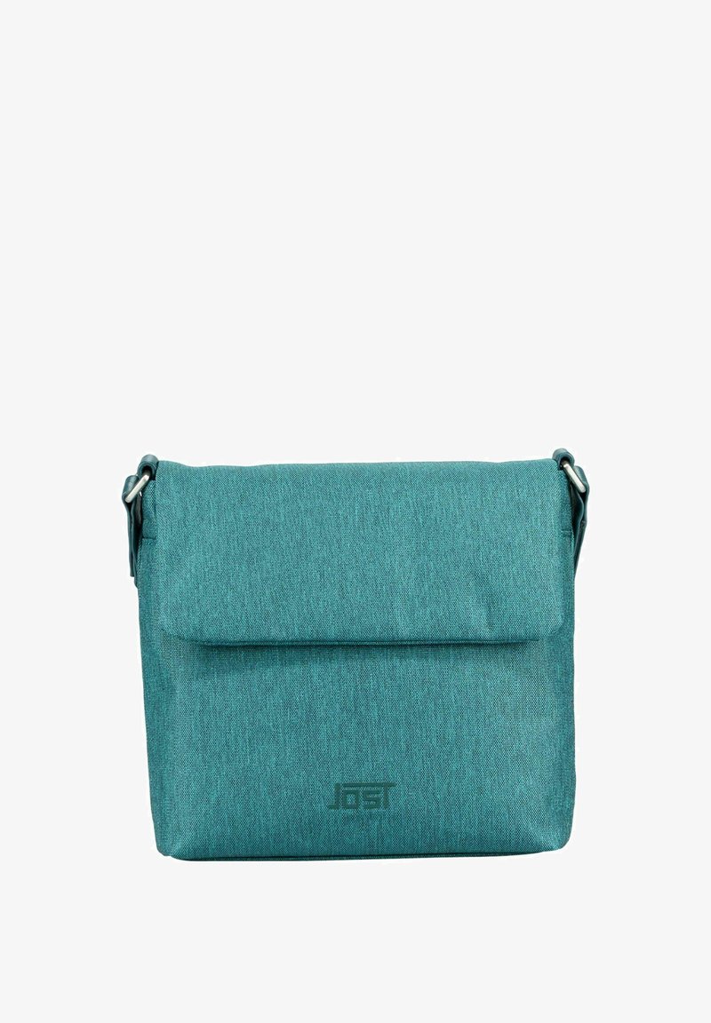 Teal crossbody bag with a textured finish, flap closure, and a logo on the front. Adjustable strap and sturdy fabric material.