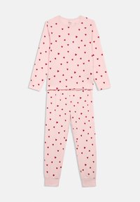 Pink pajama set with long sleeves featuring a pattern of small red hearts. The top and pants have elasticated cuffs and waistband.