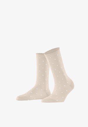 Chaussettes beiges mi-mollet à petits pois blancs et bords festonnés, présentées côte à côte sur un fond blanc.