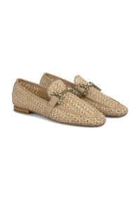 Beige woven loafers featuring a textured upper, a smooth leather band, and a decorative chain accent across the front. Flat wooden heel.