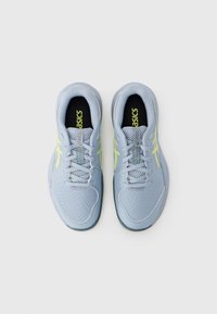 Αθλητικά παπούτσια σε ανοιχτό μπλε χρώμα με ανώτερο μέρος από δίχτυ, στρογγυλεμένη μύτη και αντιθετικές κίτρινες λεπτομέρειες. Διαθέτουν σχέδιο με κορδόνια και υφή στη σόλα για καλύτερη πρόσφυση.