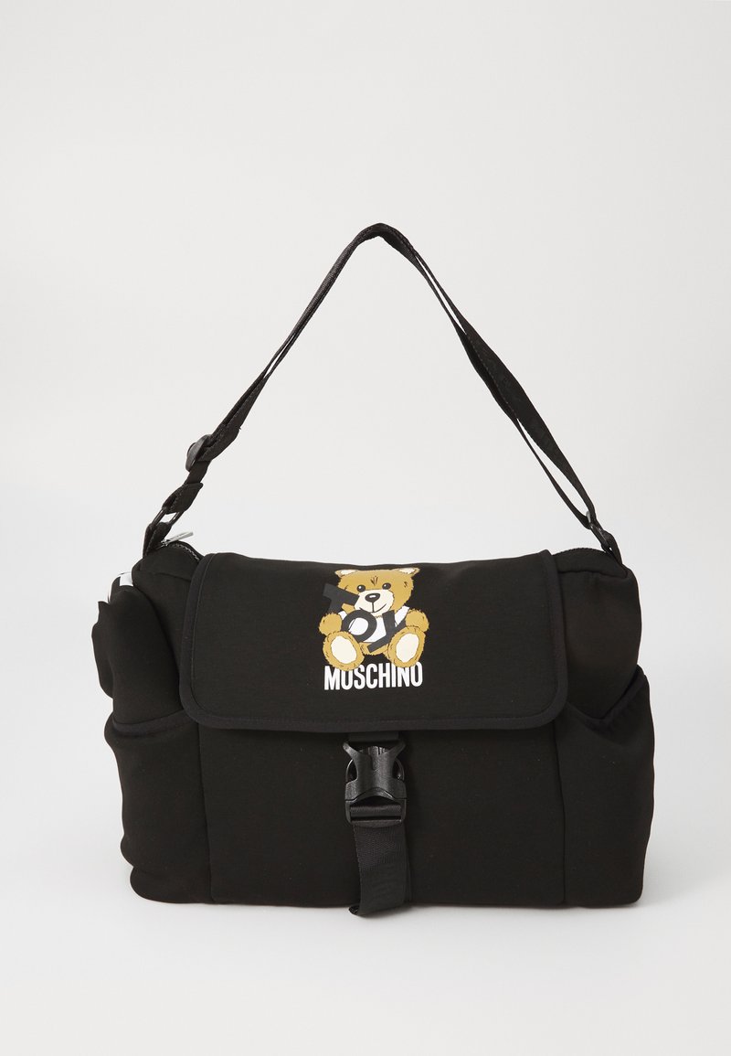 Black fabric shoulder bag with adjustable strap, featuring a front flap, a cartoon bear design, and brand logo. Secured with a clip.