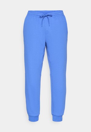 Pantaloni tuta blu realizzati in un tessuto liscio con vita elastica, cordino regolabile, tasche laterali e polsini a coste.