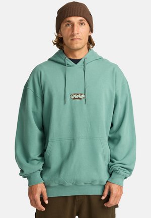 Teal hoodie with a front pocket, drawstring hood, and ribbed cuffs. Features a small embroidered logo on the chest. Soft, relaxed fit.
