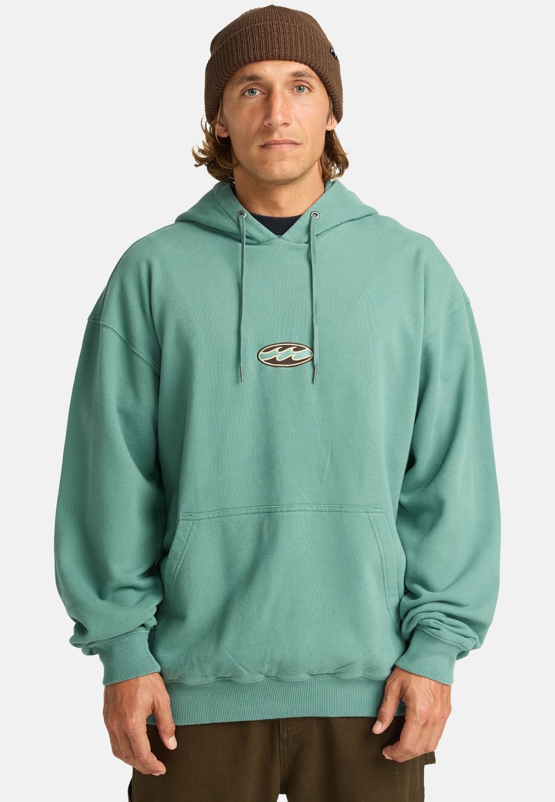 Teal hoodie with a front pocket, drawstring hood, and ribbed cuffs. Features a small embroidered logo on the chest. Soft, relaxed fit.