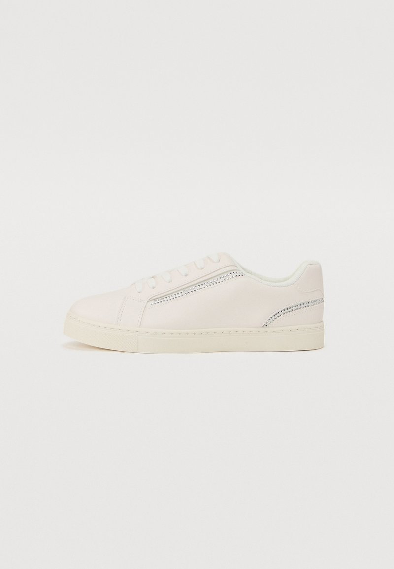 Light pink leather sneakers with a flat cream sole, rounded toe, and tonal stitching. Features a side decorative perforation detail.