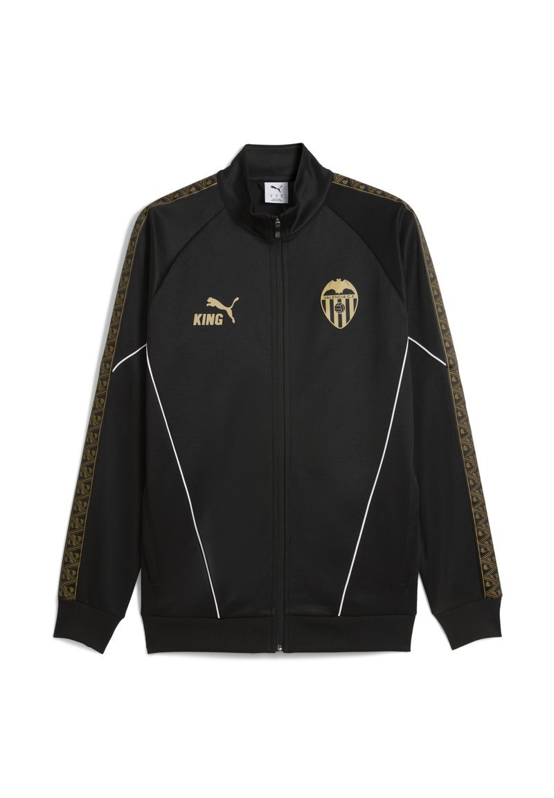 Svart zip-up jacka med guldaccent, med en logotyp och ordet "KING" i guld. Sidopanelerna har geometriska mönster. Vita kantdetaljer.