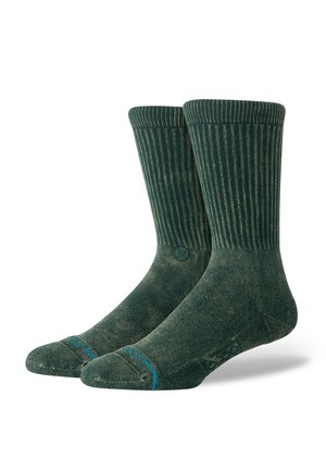 Green ribbed socks with a textured finish, featuring a blue accent at the toe and a circular logo on the side.