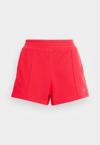 Shorts rouges avec une ceinture élastique, fabriqués en tissu lisse. Comprend deux poches latérales et un petit logo sur le bas côté.