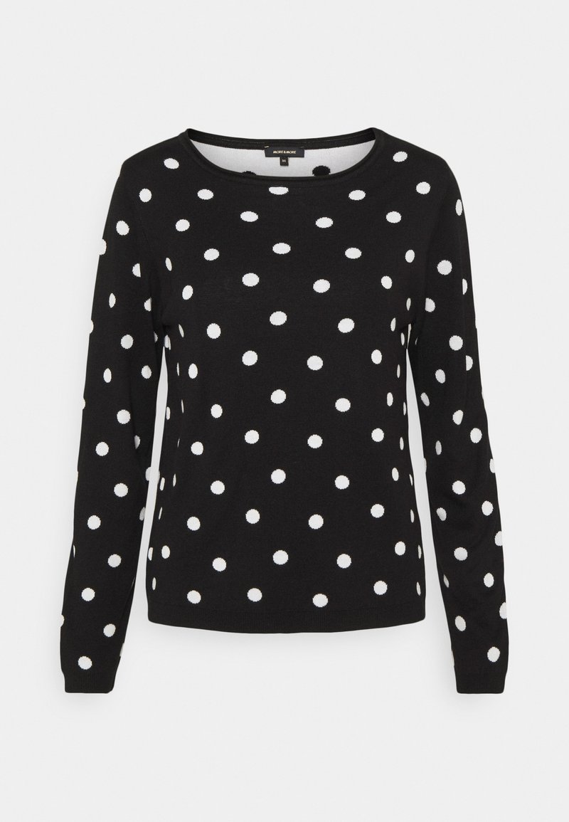 Pull noir à manches longues avec encolure ronde et pois blancs répartis de manière uniforme sur le corps et les manches.