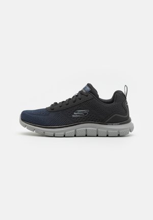 Black and navy mesh athletic shoe with a lightweight rubber sole, featuring a textured upper, round laces, and a logo on the side.