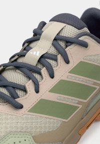Αθλητικό παπούτσι ελαφρού βάρους με πλεκτό και συνθετικό επάνω μέρος σε γκρι, μπεζ και πράσινο. Διαθέτει υφασμένη σόλα και ενισχυμένη προστατευτική μύτη.