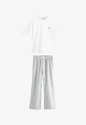 White short-sleeve t-shirt with a small black "self." logo, paired with gray and white striped, loose-fitting pajama pants with an elastic waistband.