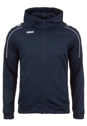 Marineblauwe sportjack met een voorzijde rits, capuchon en witte accentstrepen op de mouwen. Bevat het "JAKO" logo op de linkerschouder.