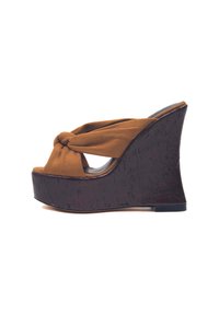 Sandalo wedge marrone con upper in tessuto annodato e una piattaforma in legno scuro texture. Design open-toe, caratterizzato da un tacco alto e angolato.