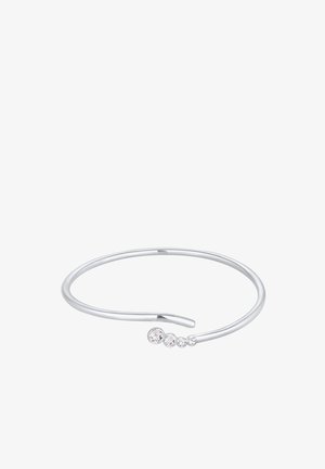 Bracelet en argent avec un design épuré, comprenant quatre gemmes transparentes graduées disposées sur un côté. Texture lisse.
